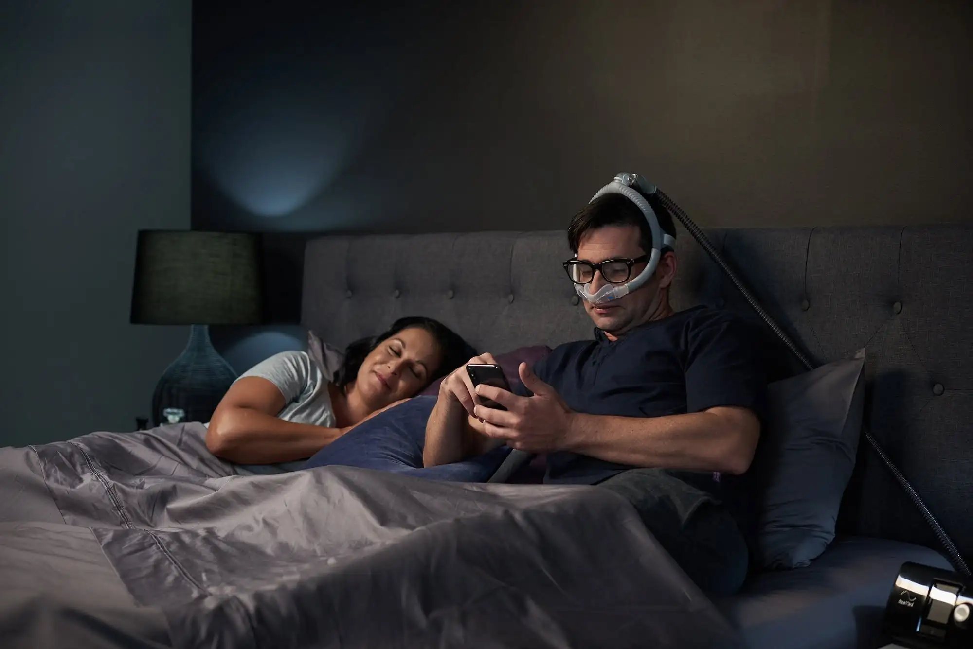 Patient using a CPAP therapy device at night
